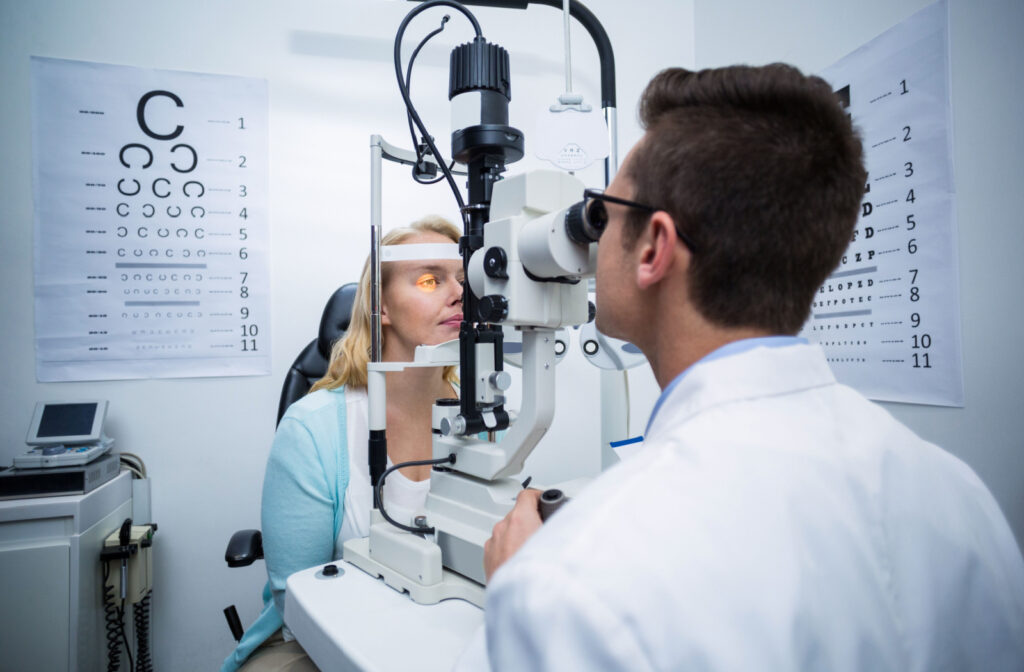 An optometrist performing a slit-lamp exam to detect eye problems.
