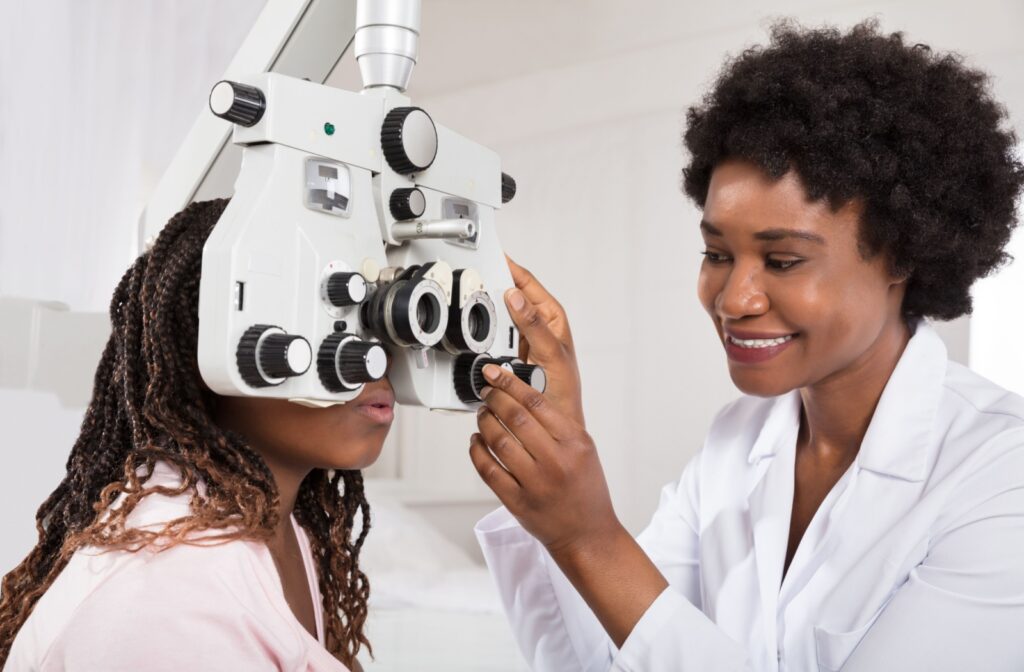 A female eye doctor conducting an eye exam on her patient.