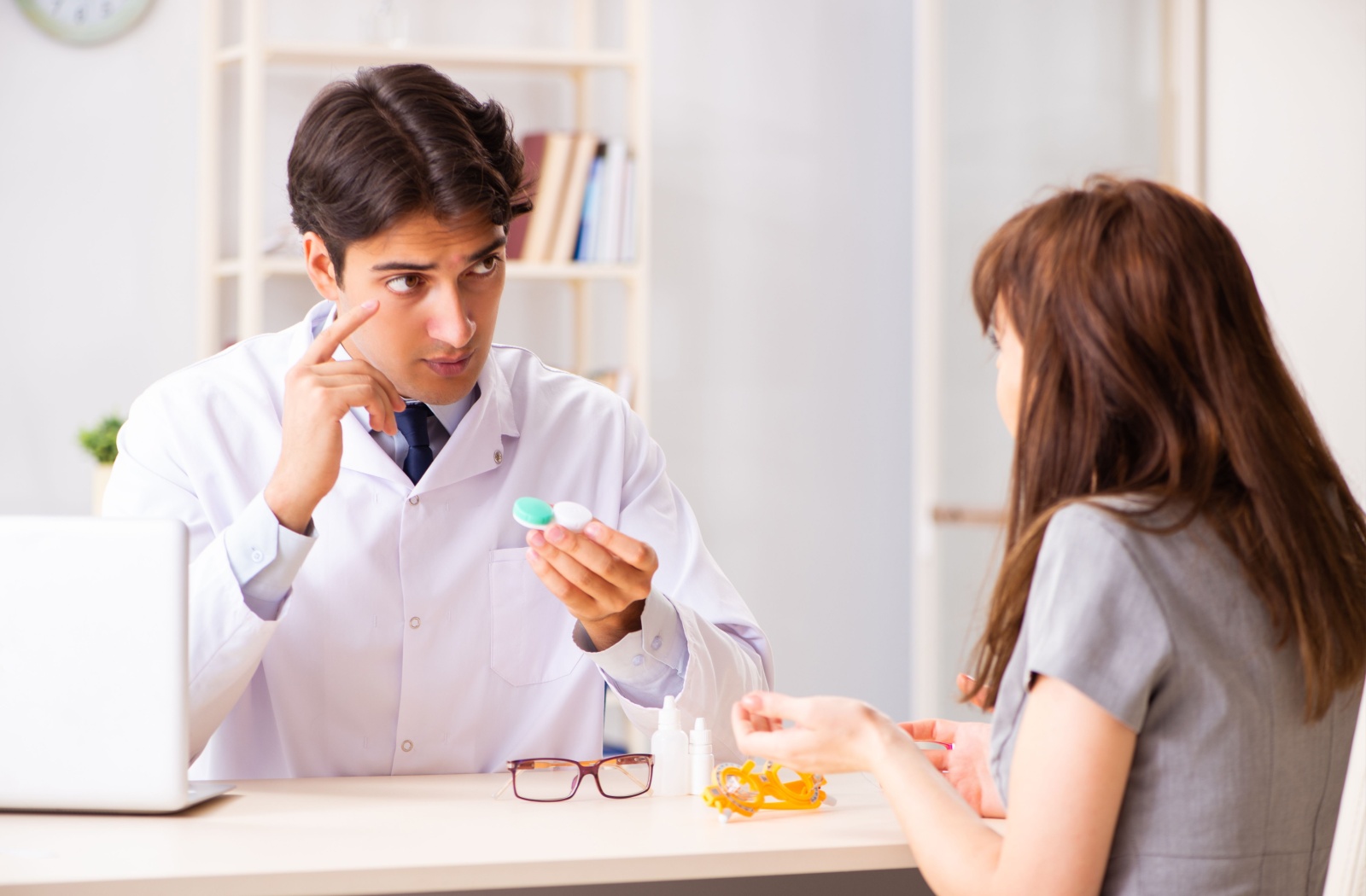 A young patient learns the importance of contact lens wear, care, and use during their annual contact lens fitting appointment.